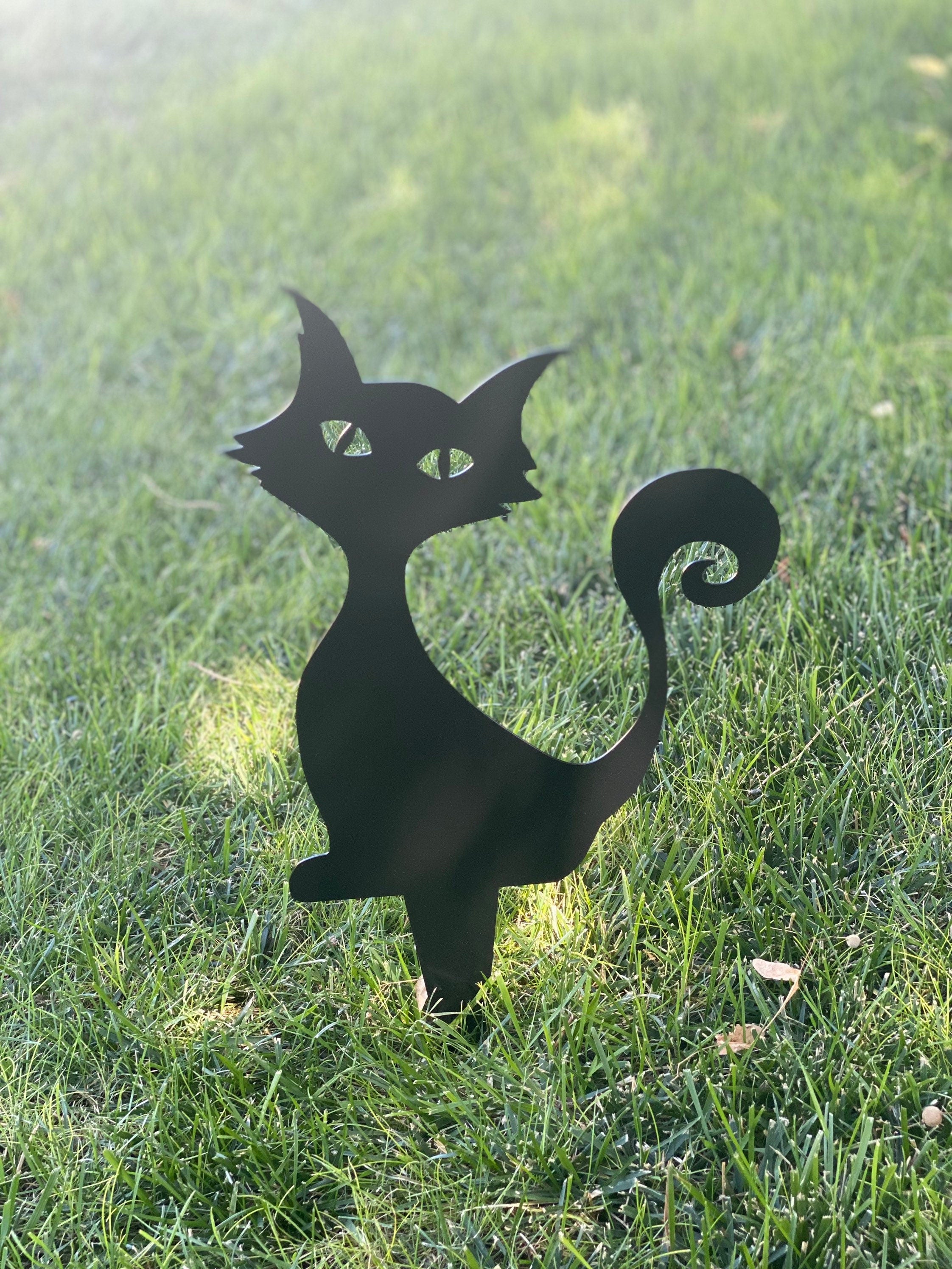 Black powder-coated metal silhouette of a curious sitting cat with an 8-inch ground stake for Halloween yard decoration